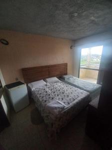 Säng eller sängar i ett rum på Pousada Casarinha