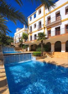 a large swimming pool in front of a building at Charming 3-storey house at residential golf resort in Muntanya la Sella