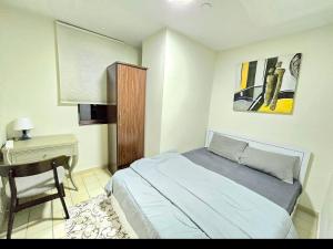 a small bedroom with a bed and a desk at 1 WORLD, Premium Hostel, JBR, Near Metro and Beach in Dubai