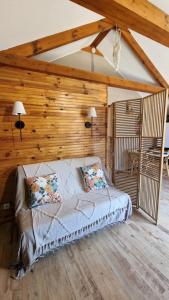 a bedroom with a bed in a room with wooden walls at Chalet bord de lac avec piscine 2A in Laffrey +27 photos