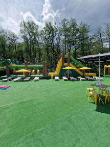 a playground with a bunch of slides in a park at Chalet bord de lac avec piscine 2A in Laffrey