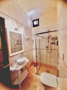 a bathroom with a glass shower and a sink at Villa Marco Aurelio in Cisano sul Neva