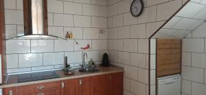 a kitchen with a sink and a clock on the wall at El Guardaviñas, entre Montes y Viñedos in Ábalos