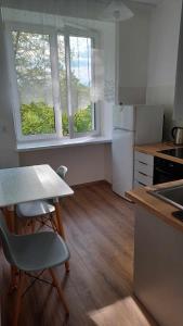 a kitchen with a table and a table and chairs at Good Apartament Skawina in Skawina