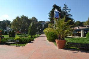 a park with a bench and a flag on a pole at Sea View Rental Iglika Apartments in Golden Sands