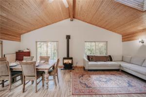a living room with a couch and a table and a fireplace at 60GS - Pets OK - Soaker Tub - Deck cabin in Glacier