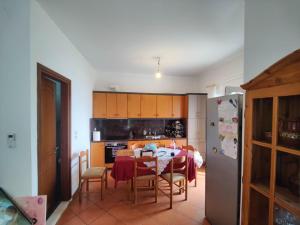 a kitchen with a table and a dining room at Villa Tsiggos in Kanallákion