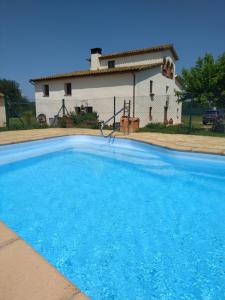 a large blue swimming pool in front of a house at CAN SIMON in San Dalmay