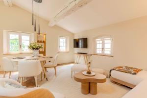 a living room with a table and a dining room at Villas by Le Yaca Saint-Tropez in Saint-Tropez