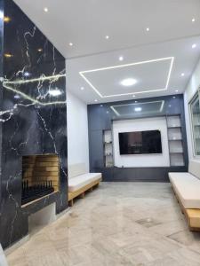 a living room with a fireplace and a flat screen tv at Villa Kyan with private pool in Bizerte +20 photos