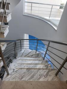 a staircase in a building with a window at Villa Kyan with private pool in Bizerte +20 photos