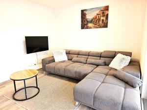 a living room with a couch and a table at MY HOME AM HEUBERG Nr 4 in Frittlingen