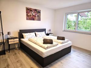 a bedroom with a large bed with two pillows at MY HOME AM HEUBERG Nr 4 in Frittlingen +38 photos