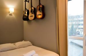 una habitación con guitarras colgando en la pared en Kamienica Poznańska 7, en Bydgoszcz