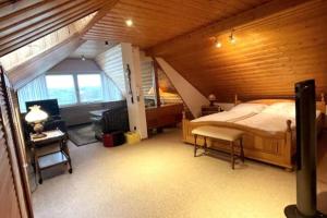 a bedroom with a large bed in a wooden room at Haus PANORAMA - Appartement Auszeit 5 in Braunlage