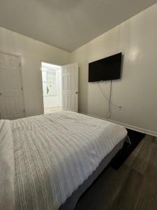 a bedroom with a bed and a television on the wall at 3 bedroom Condo in Central Park/ Times Square/ Hudson Yards in New York