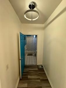 a hallway with a bathroom with a blue door at 3 bedroom Condo in Central Park/ Times Square/ Hudson Yards in New York