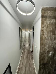 an empty hallway with a large ceiling light and a long corridor at 3 bedroom Condo in Central Park/ Times Square/ Hudson Yards in New York