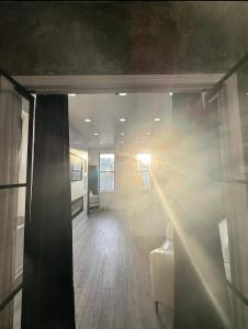 a room with a hallway with a couch and a window at 3 bedroom Condo in Central Park/ Times Square/ Hudson Yards in New York