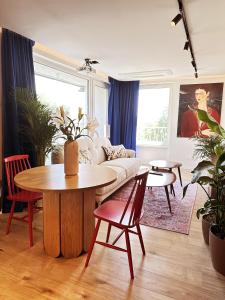 a living room with a couch and a table at Ambient lounge with sundeck and free parking in Bratislava