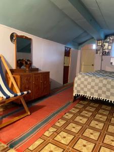a bedroom with a bed and a dresser and a mirror at Tsvirmi Zviadi's guesthouse in Mestia