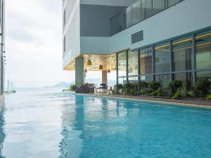 a swimming pool in front of a building at Panorama San Condotel in Nha Trang