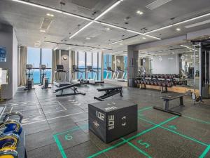 a gym with tables and benches in a room at Panorama San Condotel in Nha Trang
