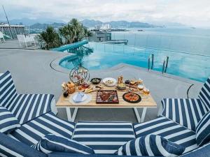 a tray of food on a table next to a pool at Panorama San Condotel in Nha Trang