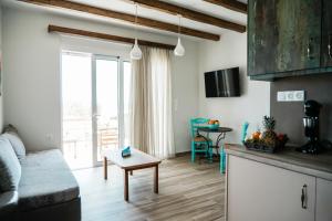 a living room with a couch and a table at Filokalia 6 - Vacation House With Sea View in Karistos +8 photos