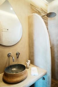 a bathroom with a wooden sink and a mirror at Filokalia 6 - Vacation House With Sea View in Karistos
