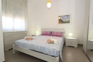 a bedroom with a bed with two bags on it at Stella apartments in Lido di Pomposa