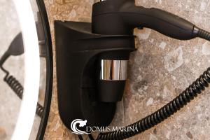 a black phone with a cord plugged into it at Domus Marina - Ionio room in Mondragone