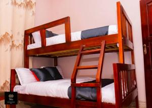 two bunk beds in a room with a bed at Nile Homestay in Jinja