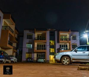 a car parked in front of a building at night at Nile Homestay in Jinja