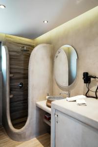 a bathroom with a sink and a mirror at Filokalia 4 Veins - Vacation House with Sea View in Karistos