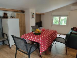 a kitchen with a table with a bowl of fruit on it at Studio dans la forêt provençale in Jouques +12 photos