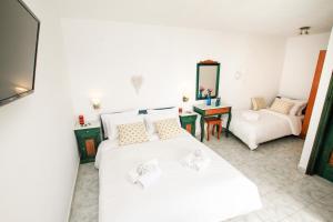 a living room with two beds and a couch at The Fisherman's House Santorini in Akrotiri