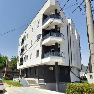 a building with balconies on the side of it at Apartman Lukić in Banja Koviljača