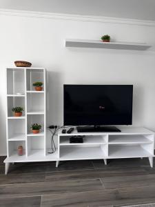a white entertainment center with a flat screen tv at MELIORA Apartment in Belgrade