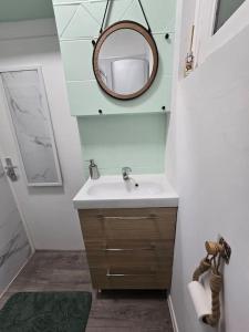 a bathroom with a sink and a mirror at Loft Romantique ~Jacuzzi privatif~ Séjour amoureux in Vieille-Toulouse +10 photos