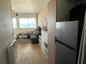 a living room with a couch and a window at Appartement magnifique VUE MER Canet plage in Canet-en-Roussillon +2 photos