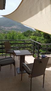 a table and chairs on a balcony with a view at Villa Kenia Flora in Maratea