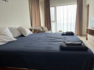 a bedroom with a large bed with a blue blanket at Privat apartament Golf Coast in Kavarna +13 photos