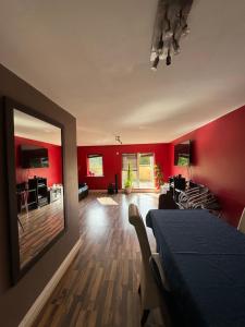 a living room with red walls and a dining room at Gc Petit Palais Dublin in Dublin