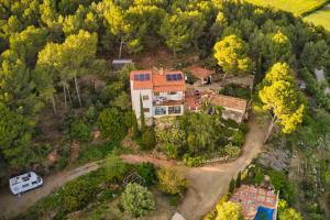 an aerial view of a house with a car parked in front at La Muntanera - Eco-friendly apartment in Figuerola +26 photos