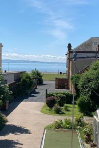 a walkway leading to a house with a view of the ocean at Ruthven in Stevenston