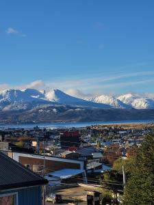 a city with snow covered mountains in the background at Hostería Bella Ushuaia in Ushuaia