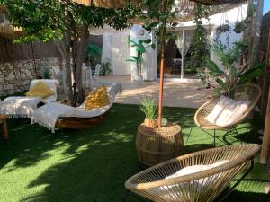 ラ・シオタにあるMaisonnette avec terrasse et jardin-Parking privé-9mn des plages à piedの庭園(椅子、テーブル、テーブル、椅子付)