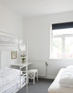 a bedroom with two bunk beds and a window at Nordliv Strand in Hasle