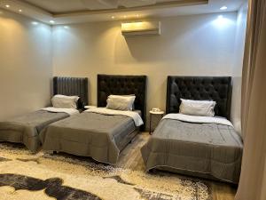 a bedroom with two beds and azeb at شقق العارض (2) in Riyadh